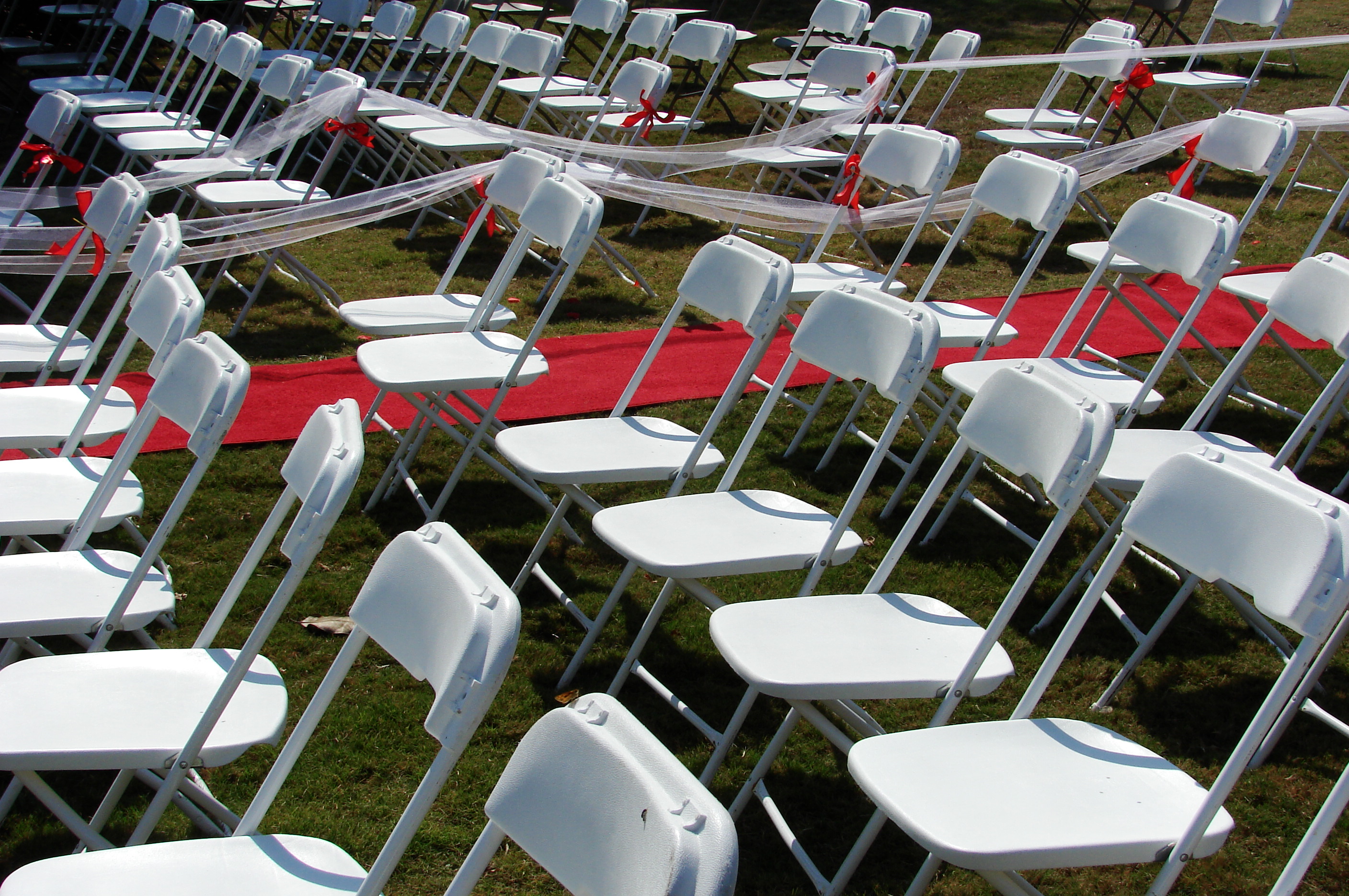 White plastic folding chairs arranged in ceremony rows