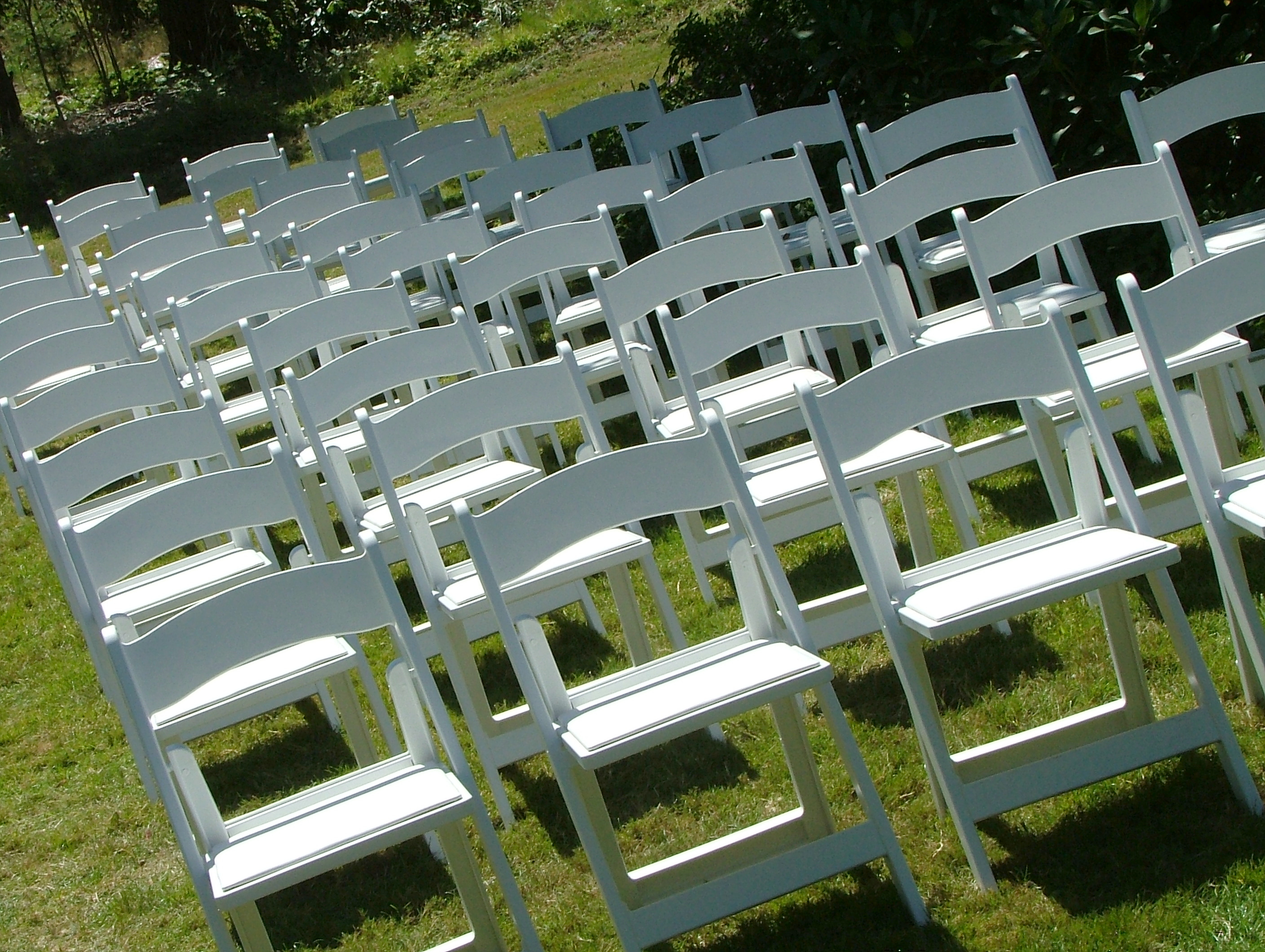 White folding chairs in rows